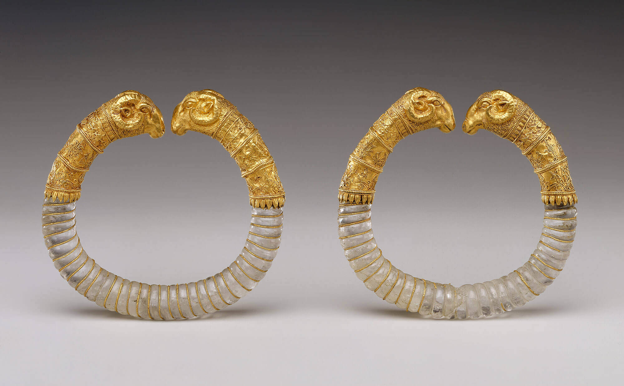 Pair of gold & rock crystal rams’-head bracelets, 330-300 BCE.