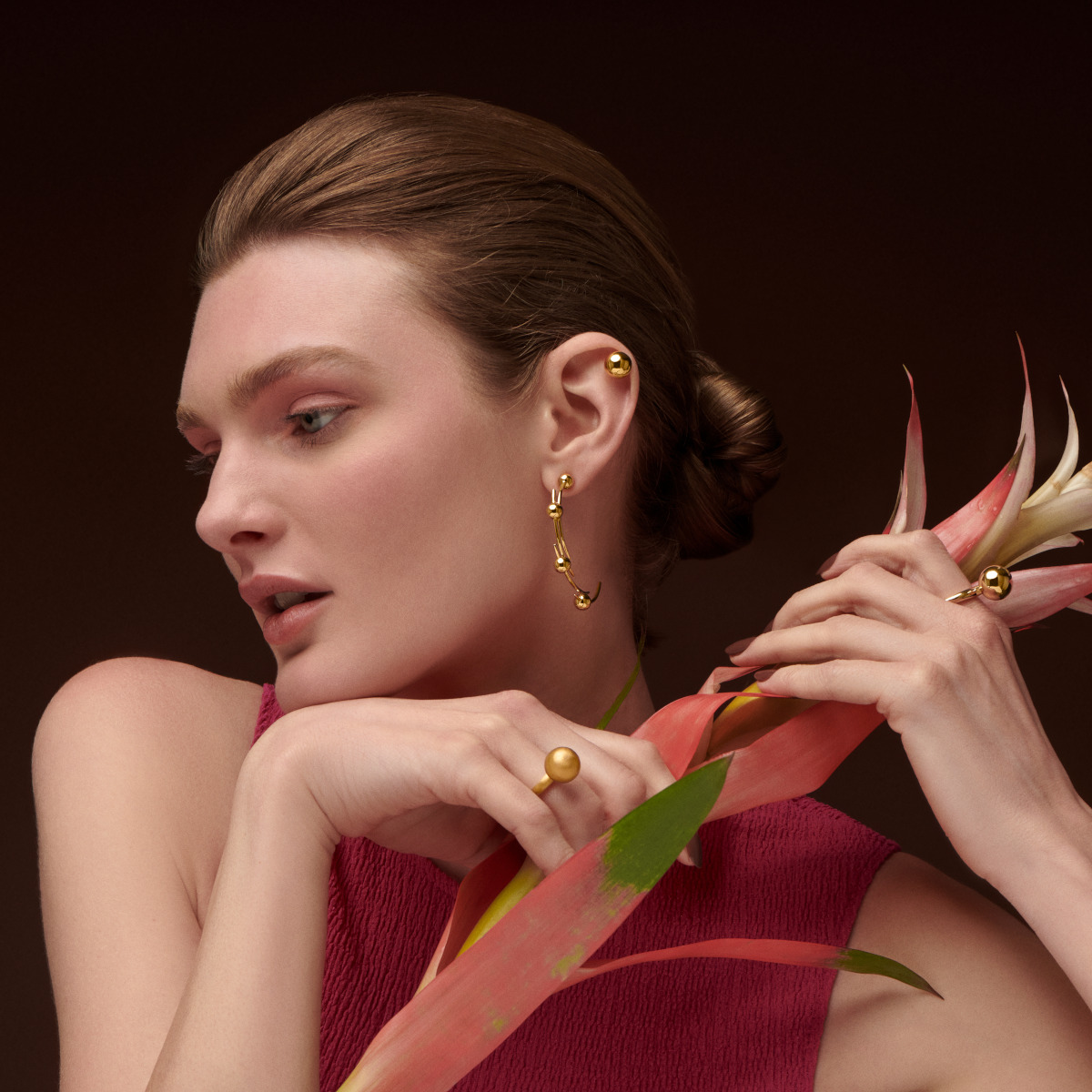 Model wearing gold jewelry for styles by generation