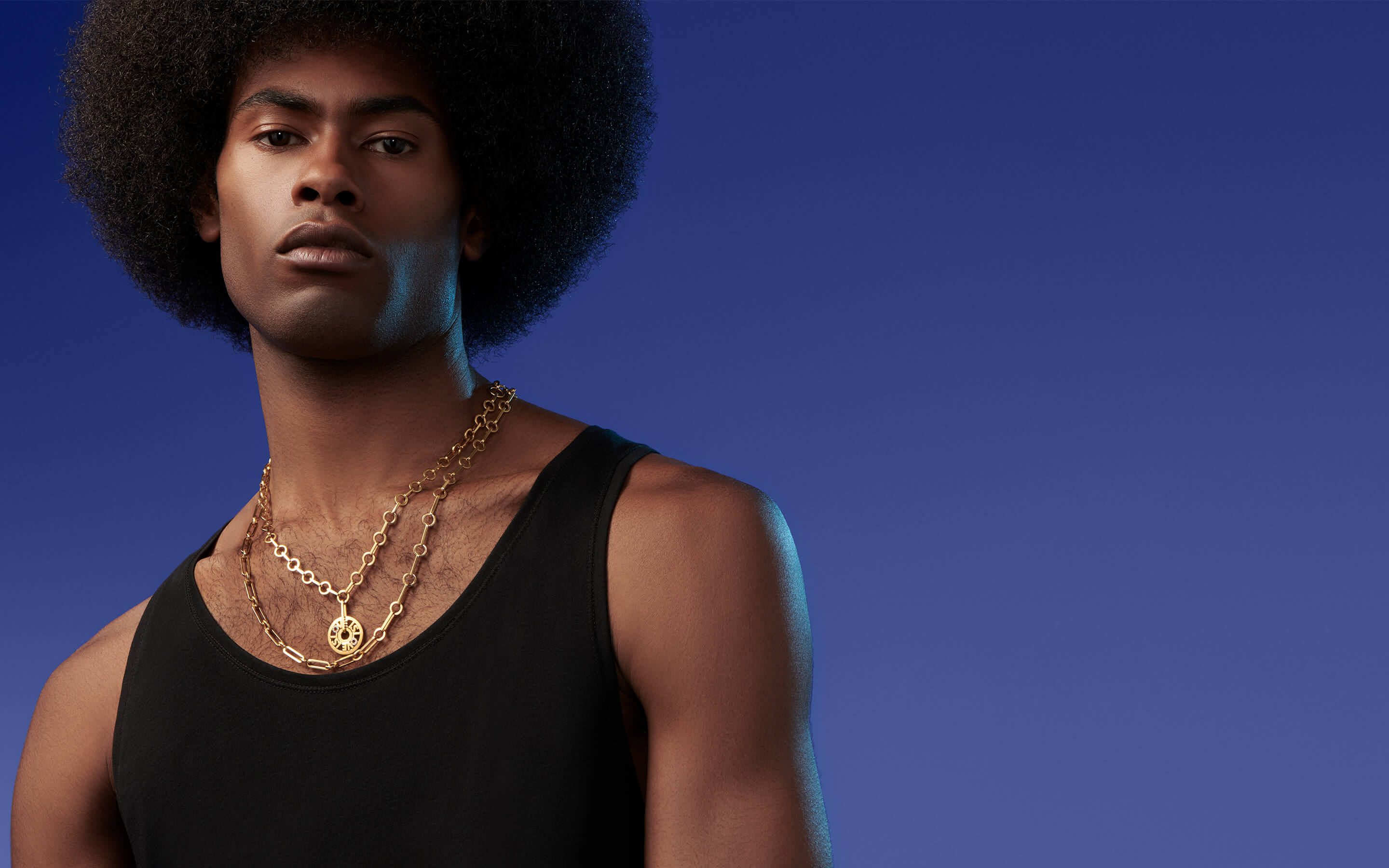 Male model wearing Auvere 22 and 24 karat gold necklaces