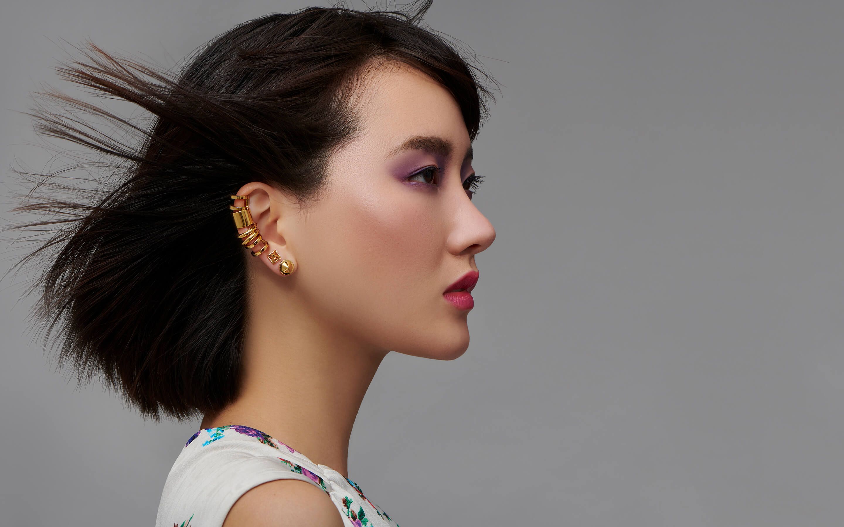 Woman model wearing Auvere 22 karat gold earrings