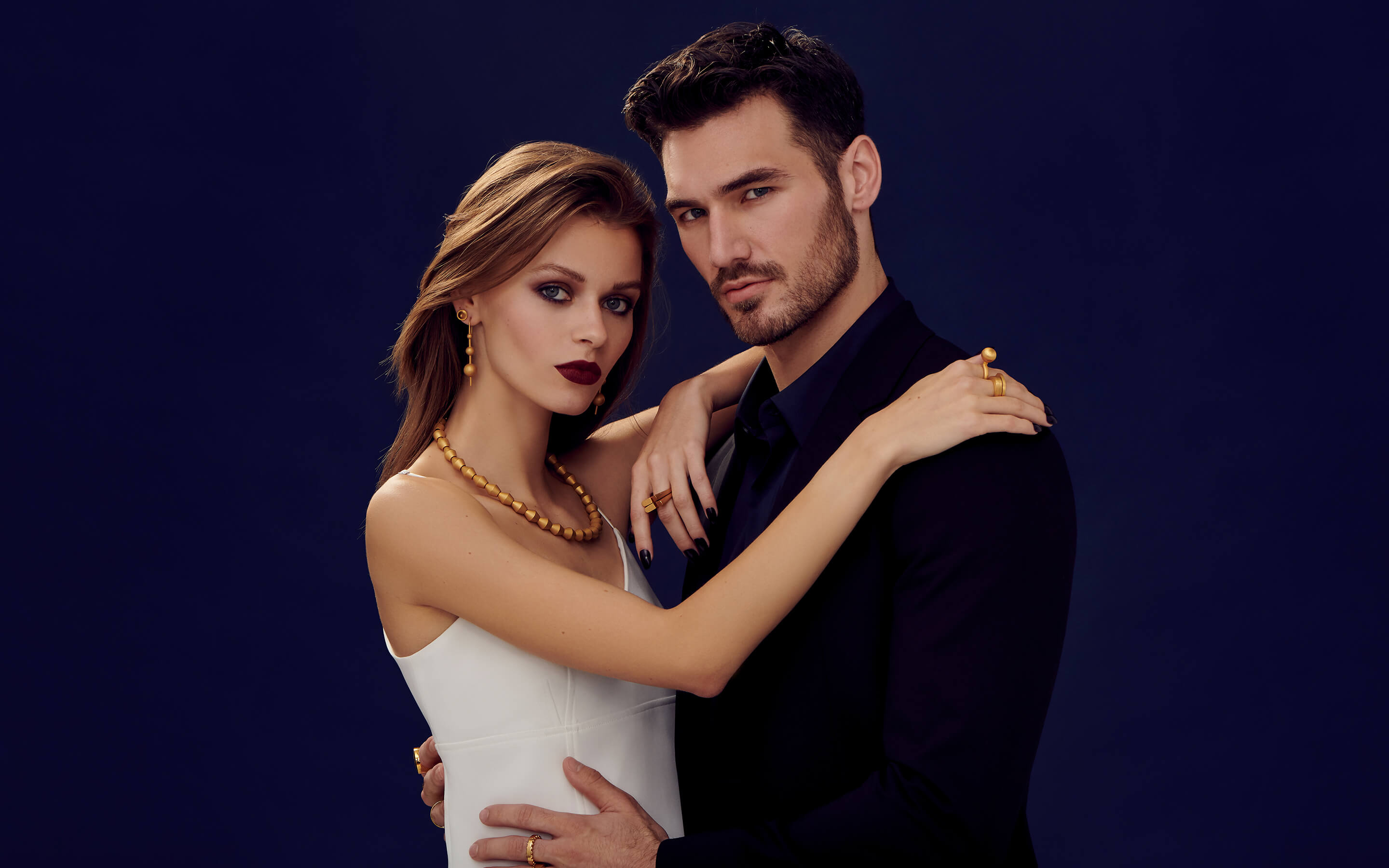 Male and woman models wearing Auvere 22 and 24 karat gold jewelry from the Gold Complex campaign