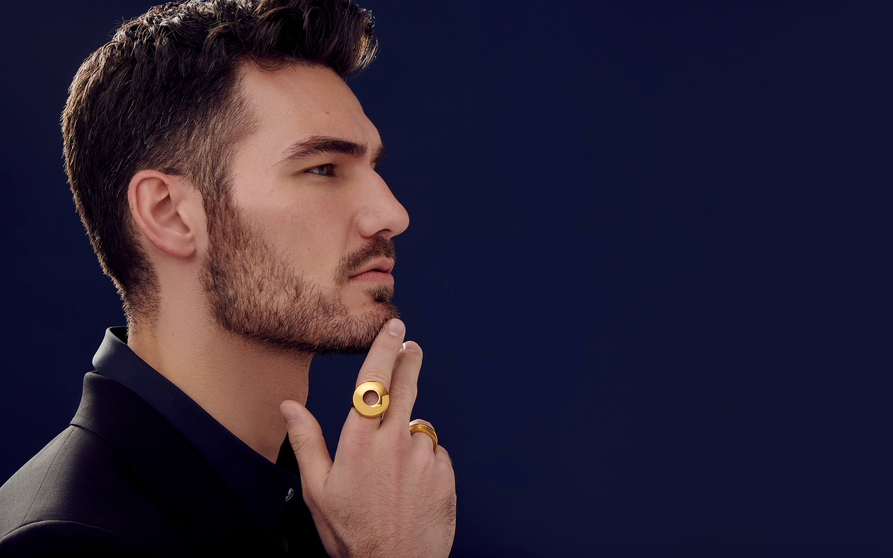Male model wearing Auvere 22 and 24 karat gold jewelry from the Gold Complex campaign