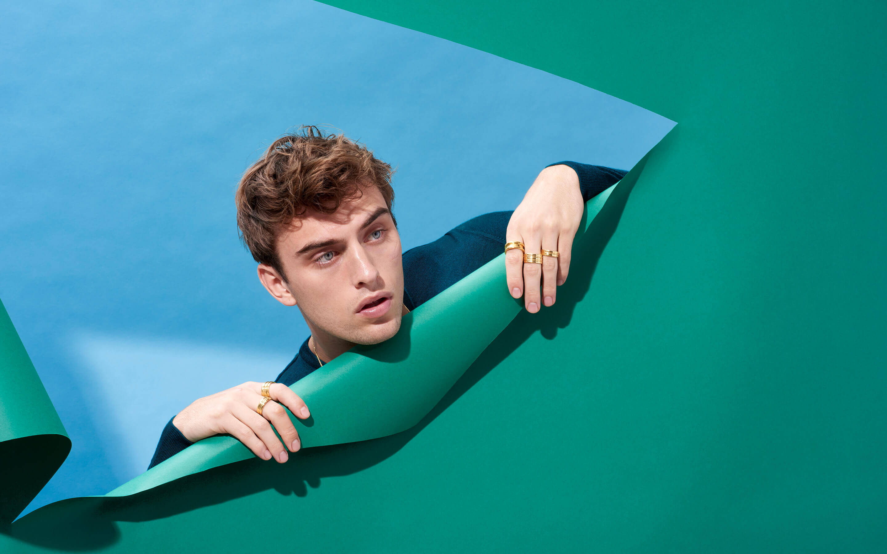 Male model wearing Auvere 22 and 24 karat gold jewelry from the Gold Play campaign